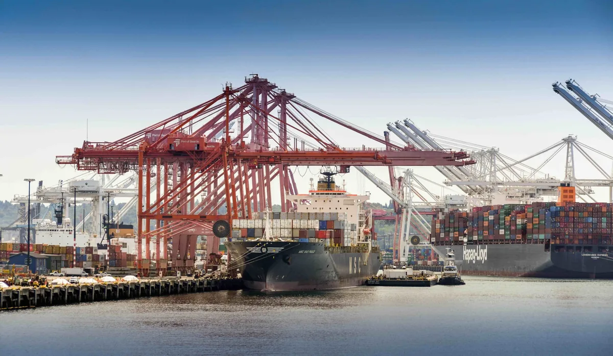 Container ship beneath marine-terminal cranes in Seattle