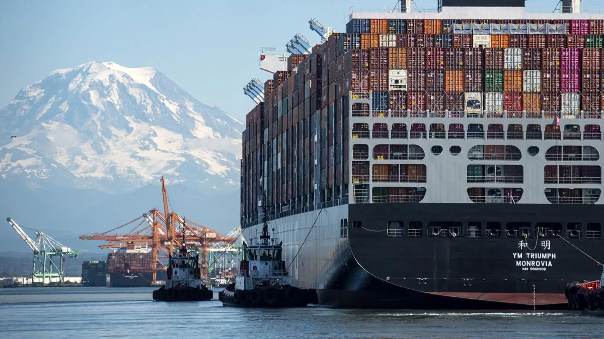 Container vessel, tugboats, cranes, and Mount Rainier at Tacoma